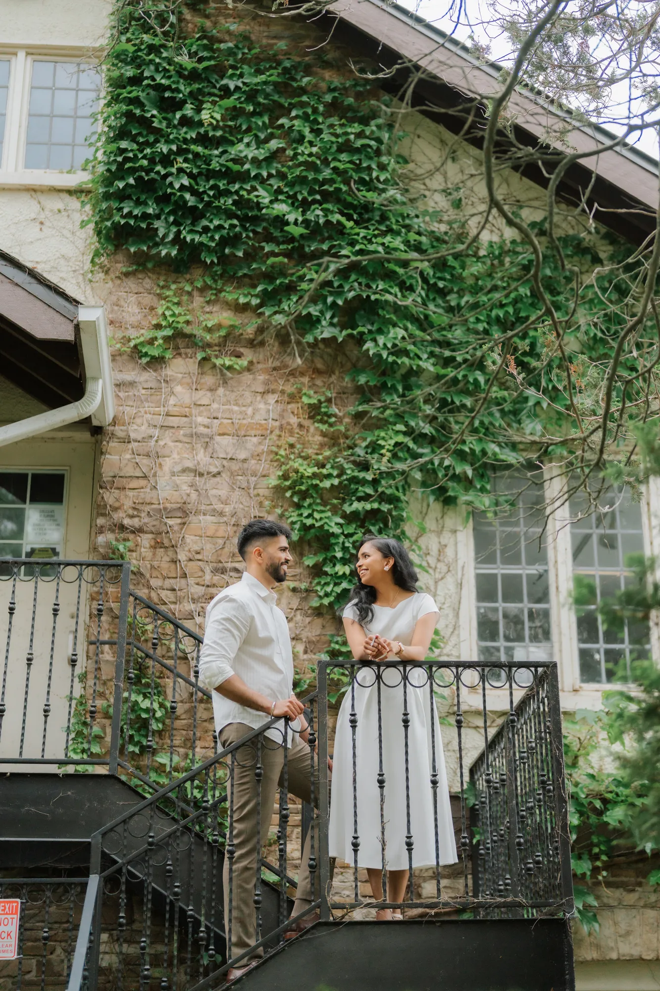 Ivy-covered building facade framed by greenery