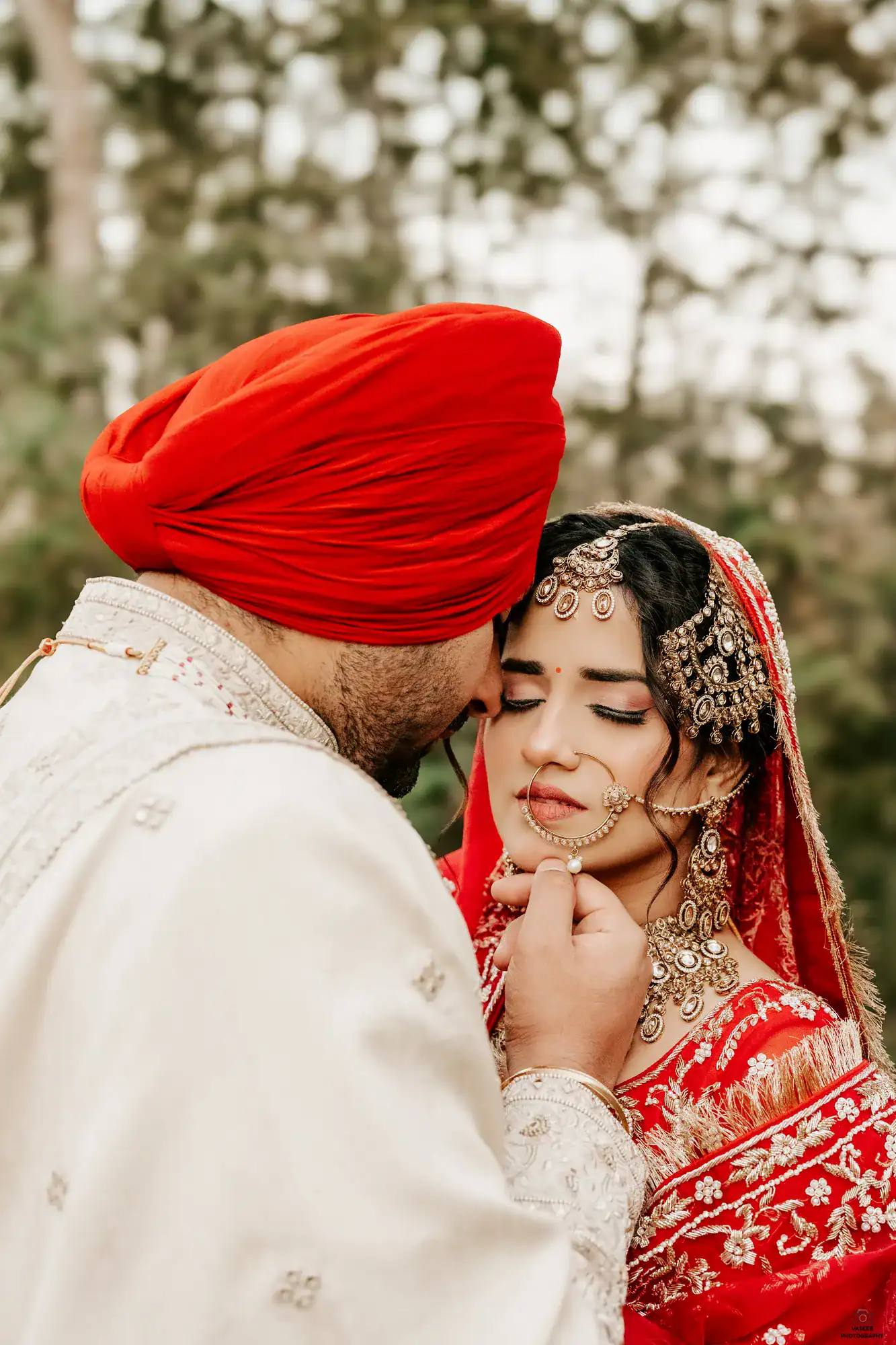 Groom gently touching the bride’s chin in a close-up portrait