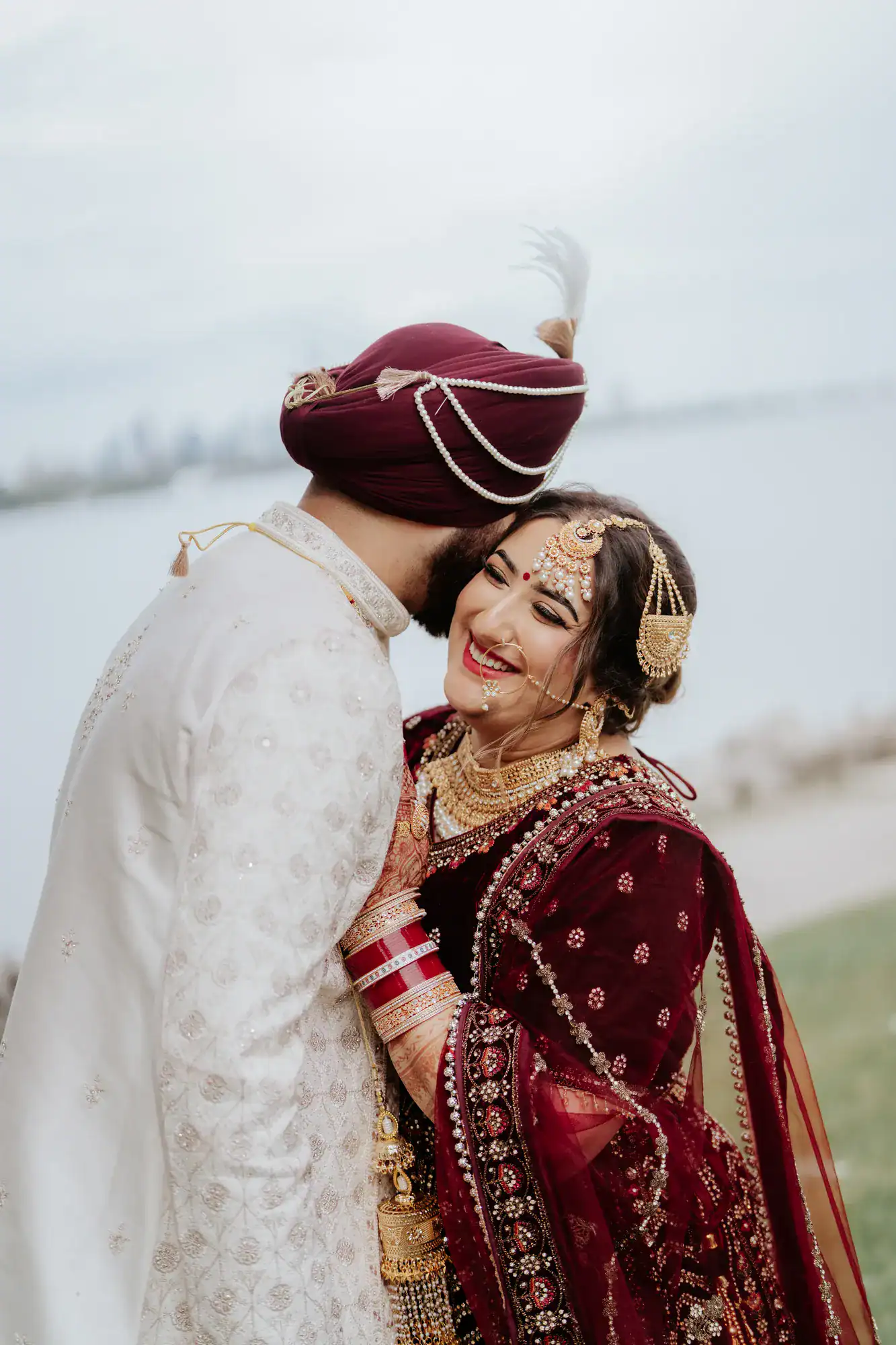 Groom kissing the bride on the cheek in a wedding portrait